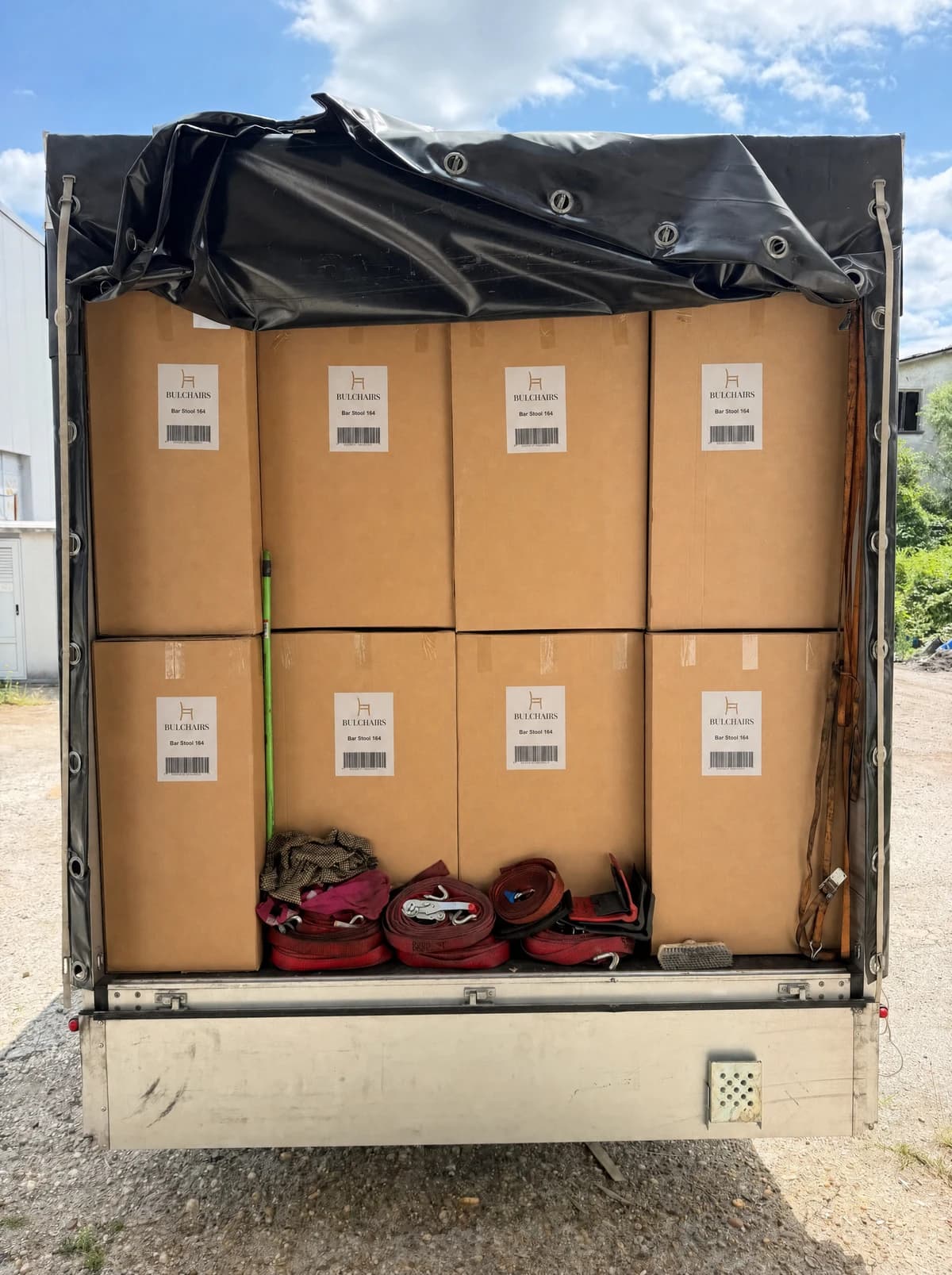Curtain-side trailer packed with labelled BulChairs cartons, tarpaulin drawn back